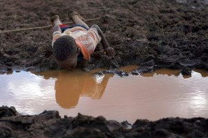 June 12, 2009: A boy drinks water from a pond in Bule Duba village, near the edge of Oroma and Somali regions of Ethiopia(Irada Humbatova/Reuters)
